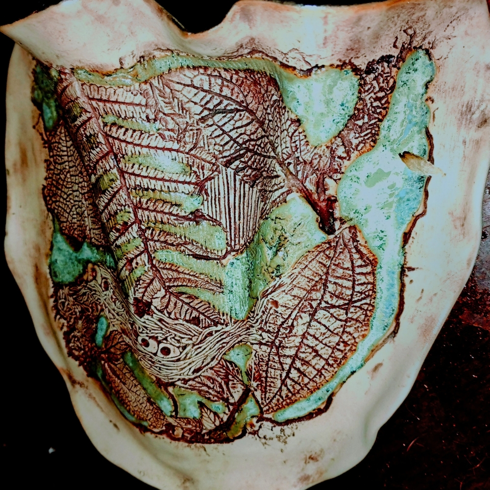 Brown and Green Ceramic Art with Intricate Design
